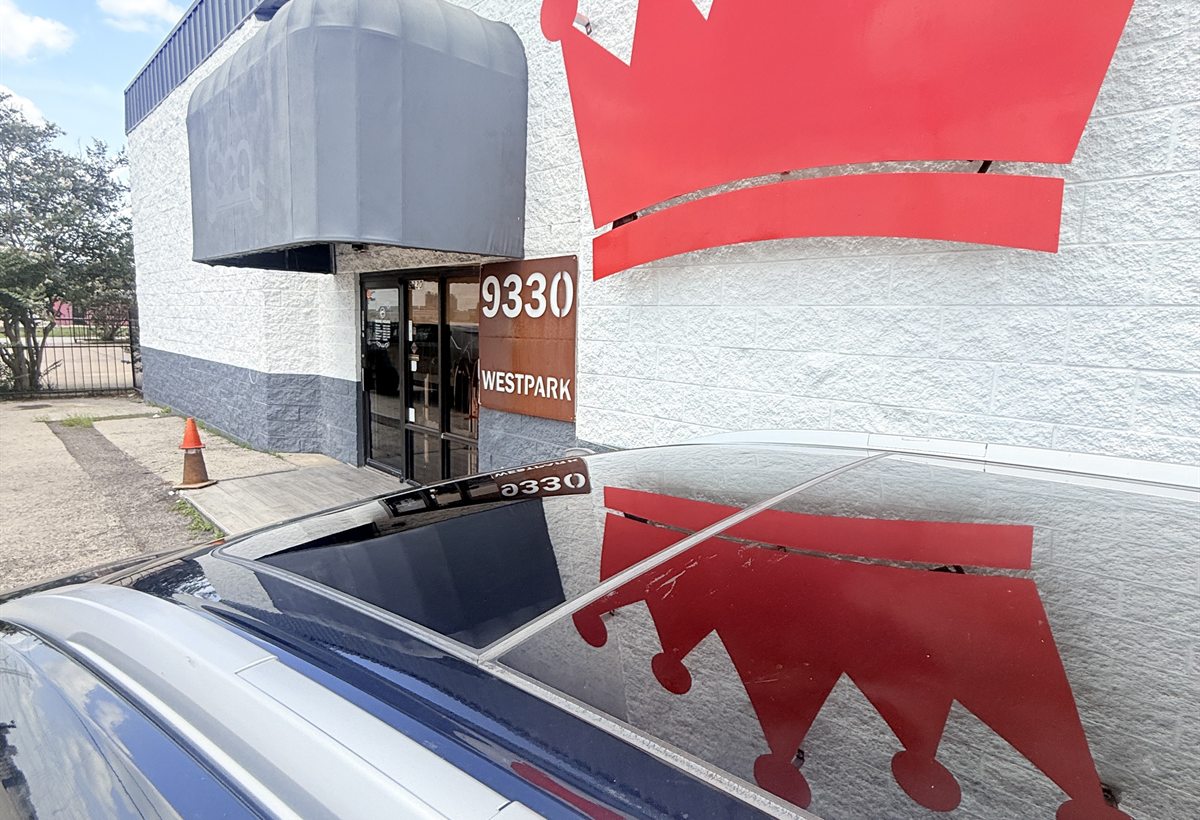 Vehicle with a completed custom sunroof parked at the Sunroof King entrance at 9330 Westpark Dr in Houston
