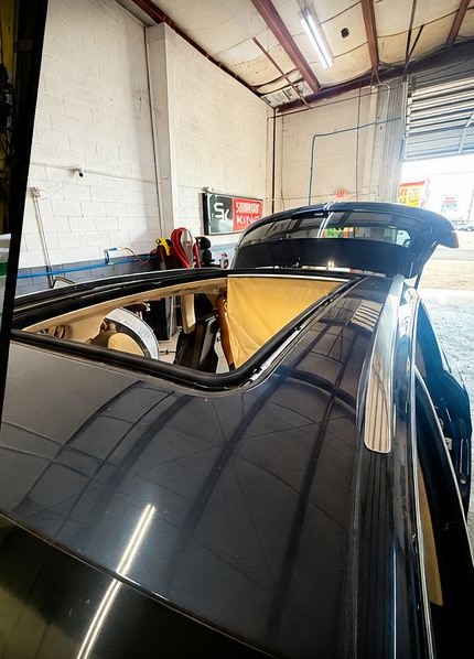 Vehicle with its sunroof open in the Sunroof King shop in Houston