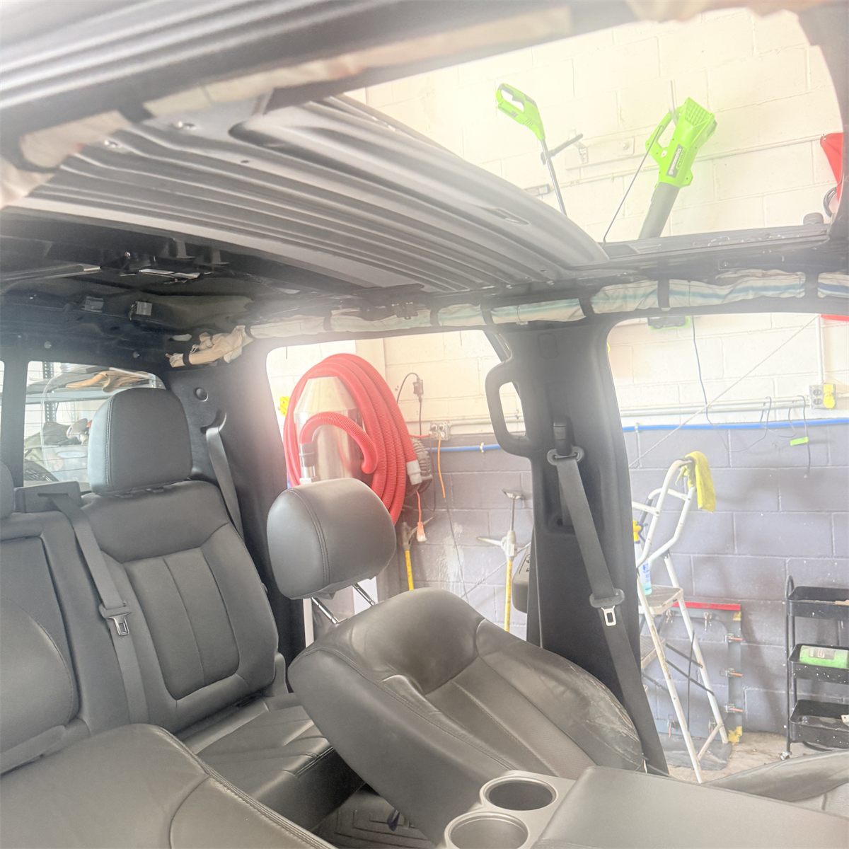 Ford panoramic sunroof mechanism being inspected and repaired at the Sunroof King shop in Houston