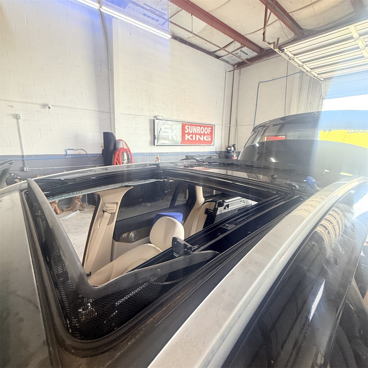 Ford panoramic sunroof track and mechanism exposed for repair at Sunroof King in Houston