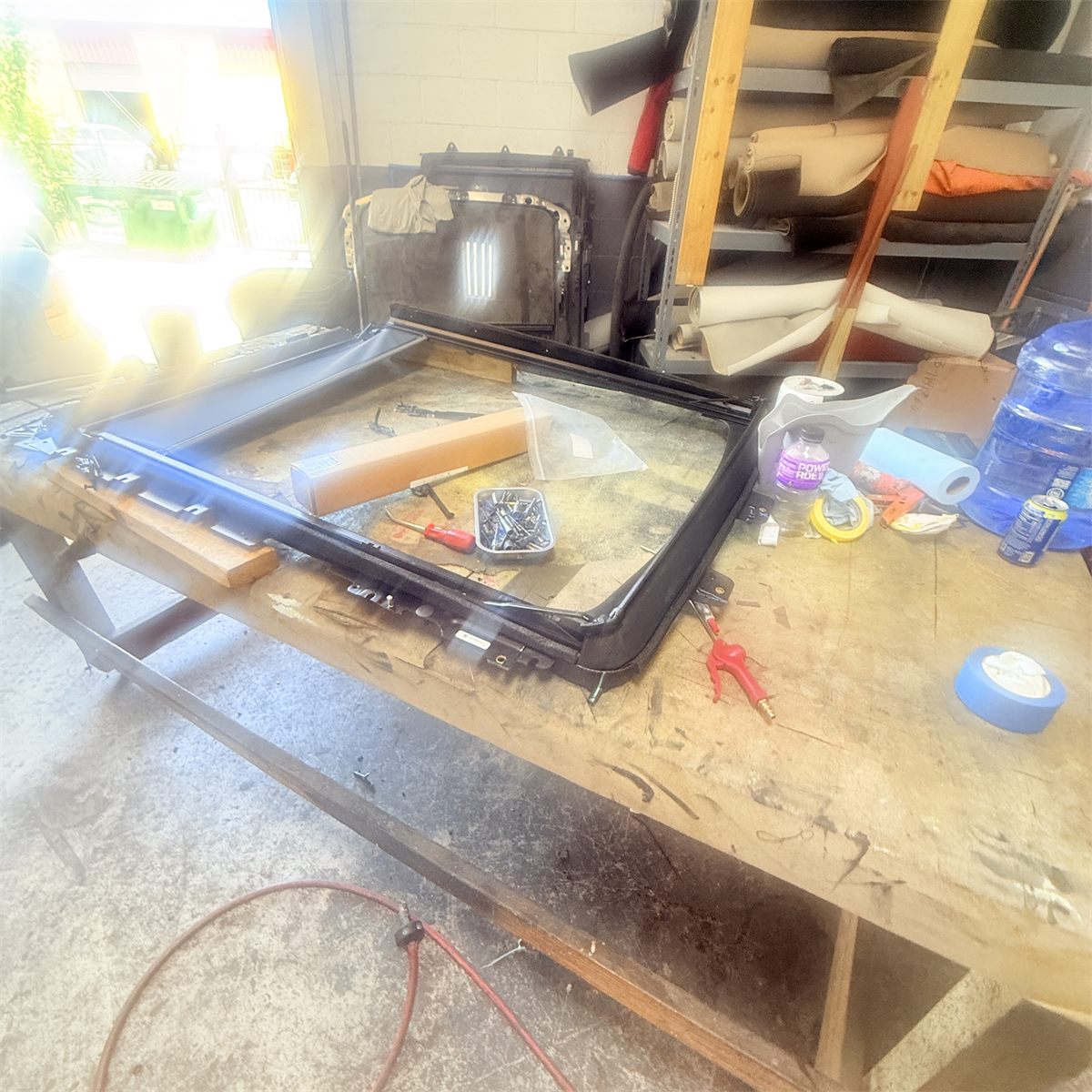 Ford sunroof cassette and track assembly on the workbench during repair at Sunroof King in Houston