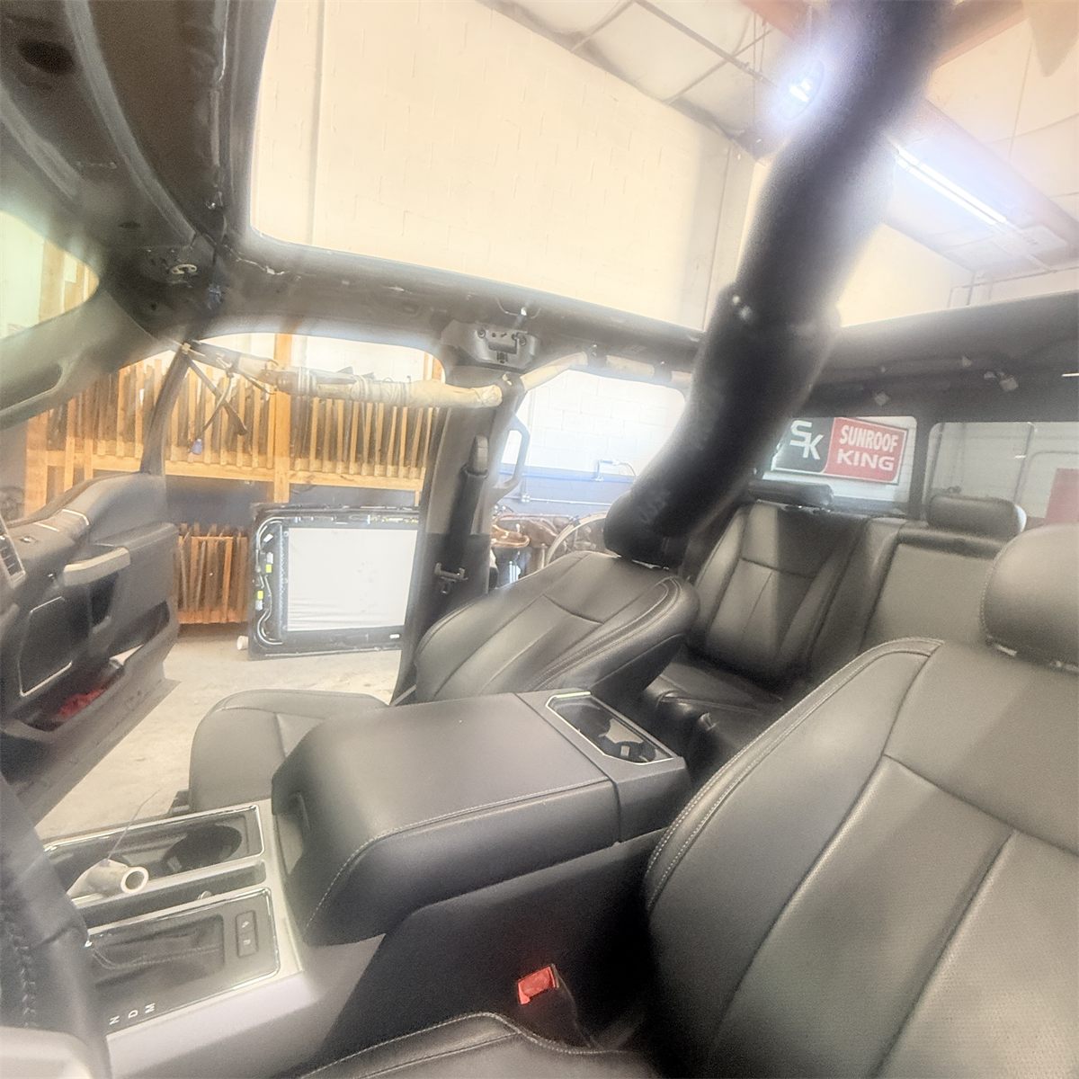 Ford interior disassembled to access the sunroof mechanism at Sunroof King in Houston