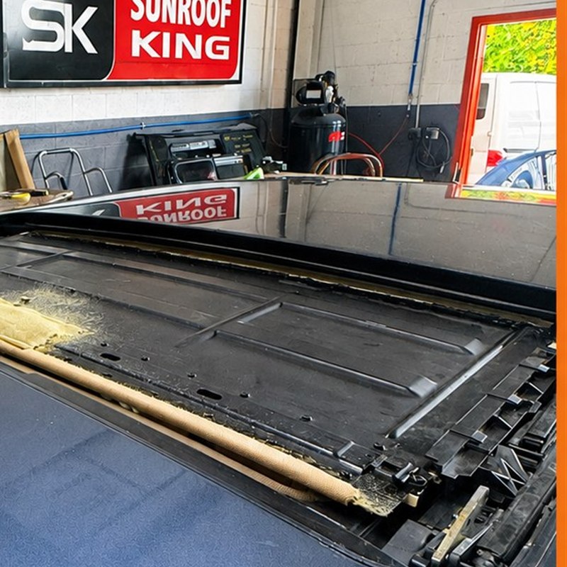 Panoramic roof opening with the glass removed, showing the frame and seal channel, at the Sunroof King shop in Houston
