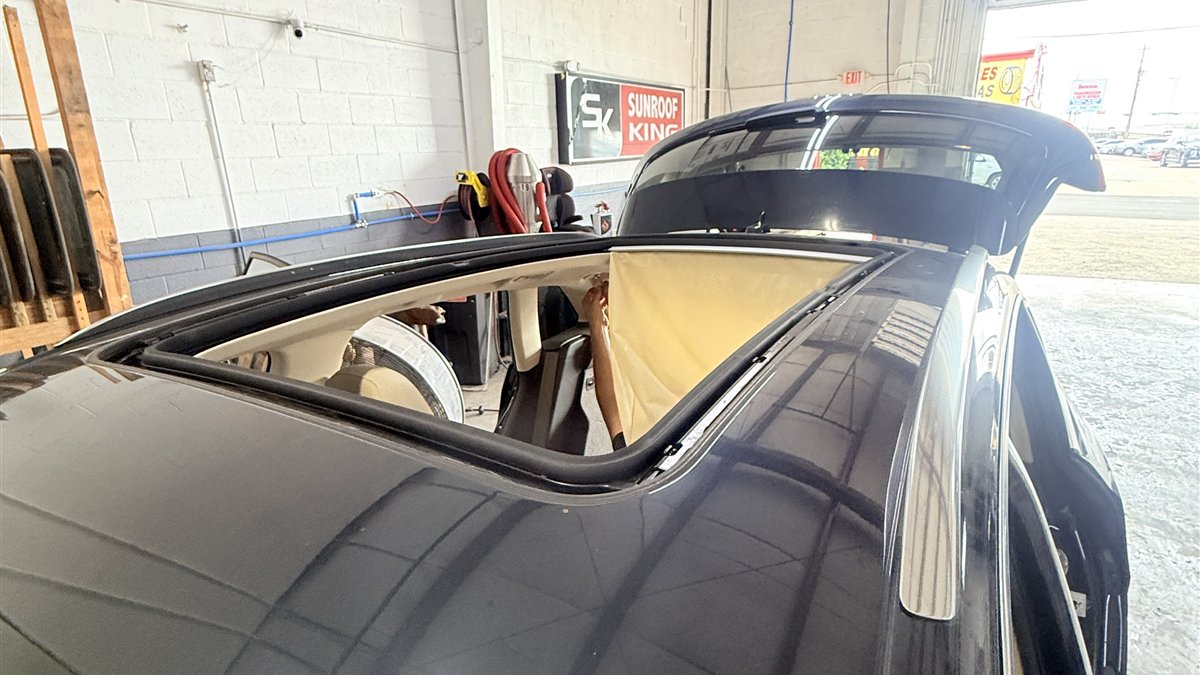 Vehicle in the Sunroof King shop with its panoramic roof open