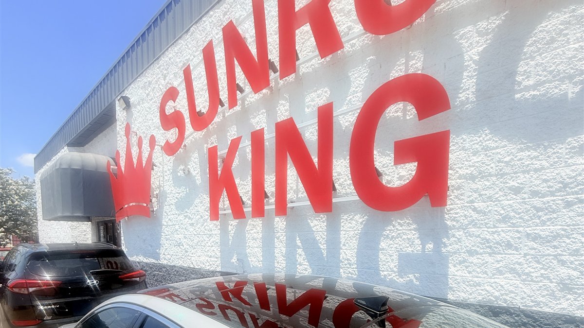 Sunroof King shop exterior signage and customer vehicles at 9330 Westpark Dr, Houston