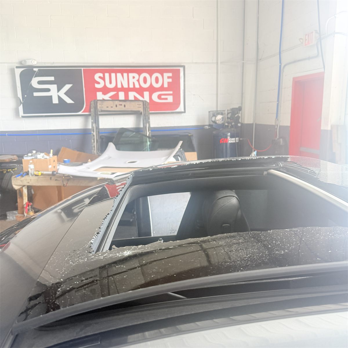 Shattered panoramic sunroof glass on a vehicle brought into the Sunroof King shop in Houston