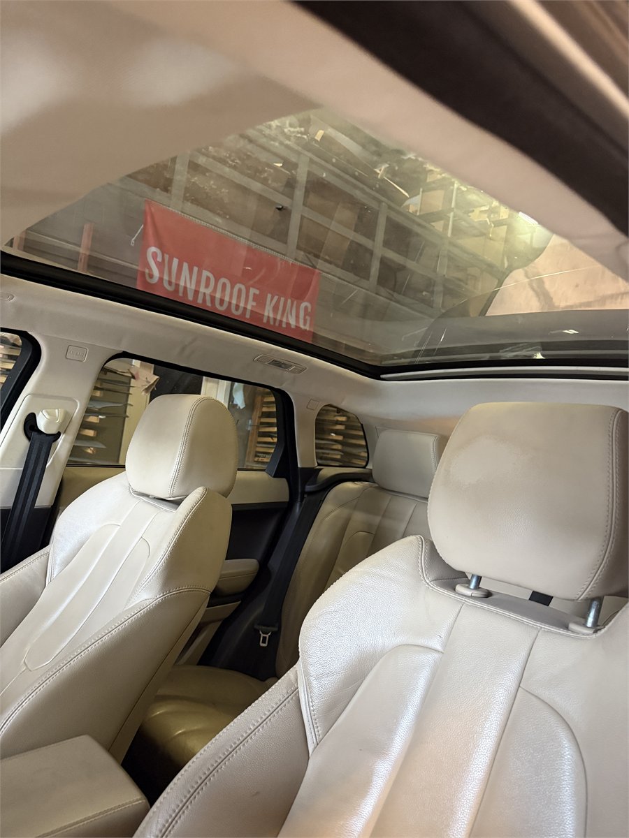 Completed panoramic sunroof shade repair seen from inside the vehicle at Sunroof King in Houston, with the shade retracted cleanly under the glass
