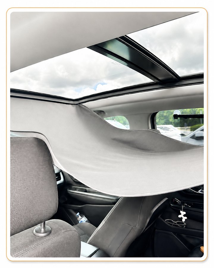 Panoramic sunroof shade sagging away from the roof and hanging down into the cabin of a vehicle at Sunroof King in Houston