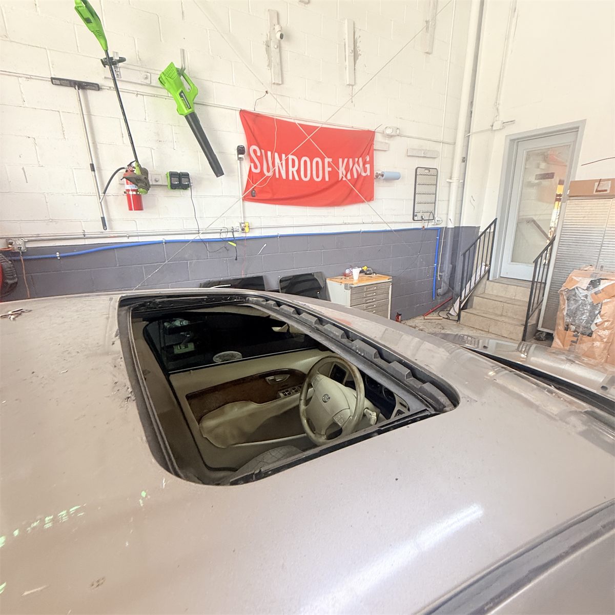 Sunroof opening cleared of broken glass at the Sunroof King shop in Houston, ready for inspection before the replacement panel is fitted