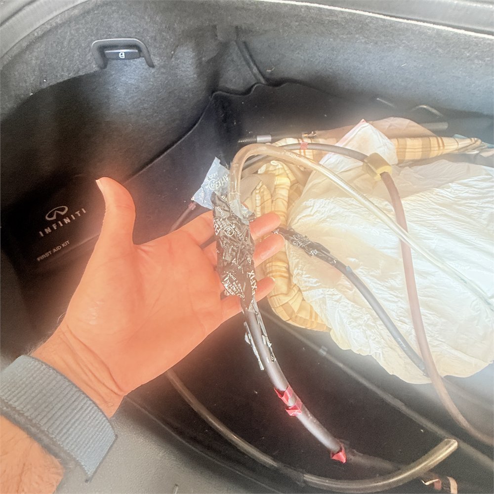 Cables and wiring being inspected during a sunroof repair at Sunroof King in Houston