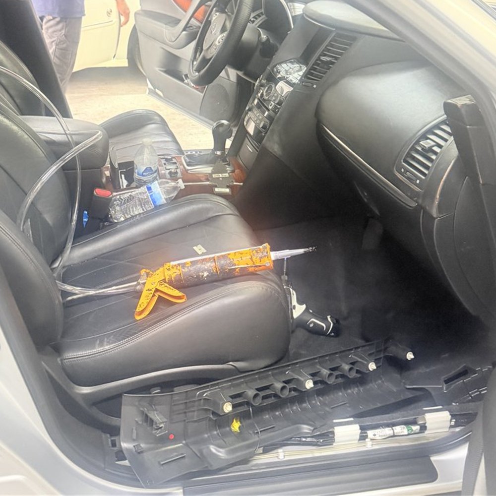 Vehicle interior at the Sunroof King shop in Houston with the trim removed and sunroof wiring and connections exposed for diagnosis