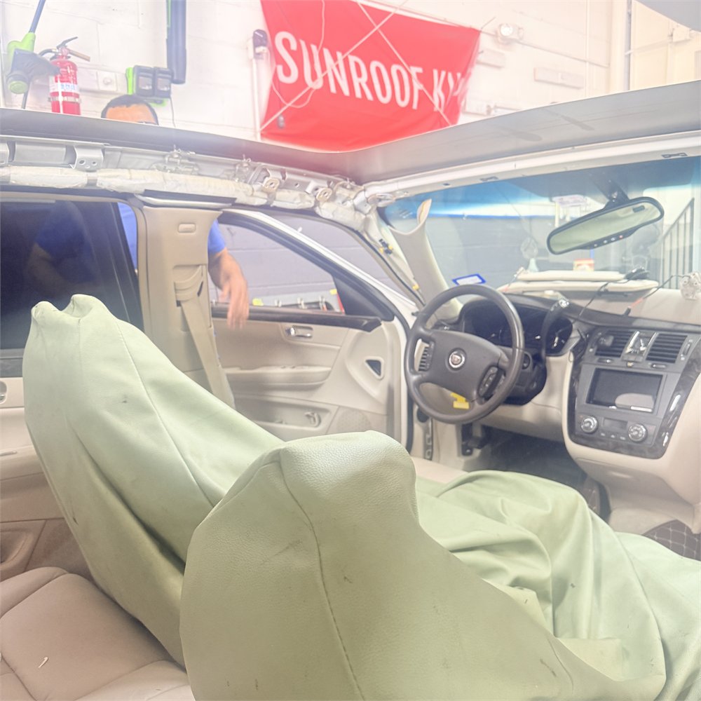 Vehicle interior with protective covers over the seats before sunroof repair work begins at Sunroof King in Houston