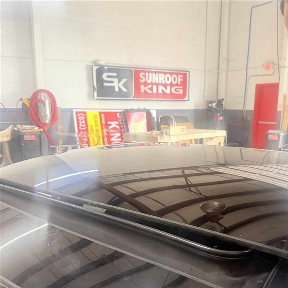 Sunroof panel raised and sitting out of line above the roof of a vehicle being assessed at Sunroof King in Houston