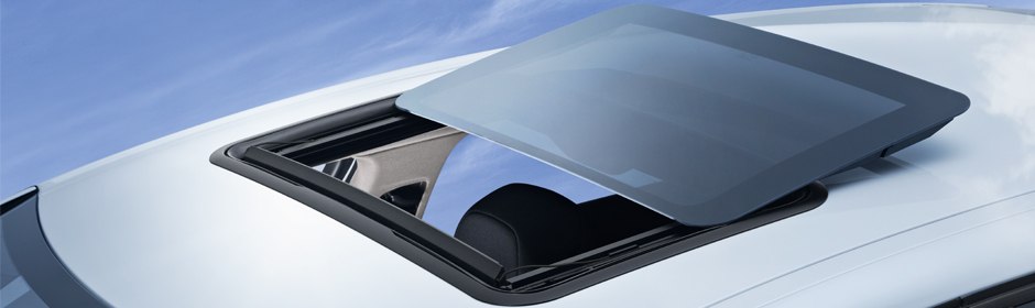 Spoiler-style sunroof panel tilted and slid above a vehicle roof