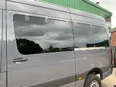 Rear side windows fitted into a Sprinter van by Sunroof King in Houston